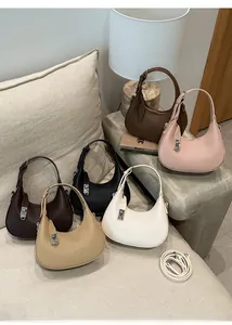 Detail showing various colors of lychee grain leather crescent bags with silver metal locks