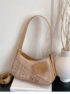 Brown leather saddle shoulder bag with suede stitching and metallic eyelet details