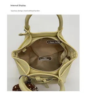 Internal view of the cream bucket bag showing spacious main pocket and zipped inner pocket