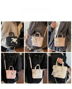 Collage of mini pebble leather bucket bags in five colors with pearl heart pendants
