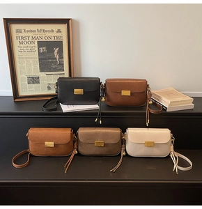 Detail view of colorful retro crossbody flap bags with gold hardware and knot strap charms