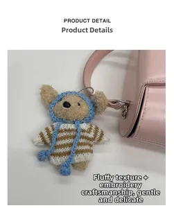Close-up of cute teddy bear plush charm with knit hat and striped sweater on pink bag