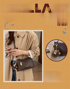 Detail of dark brown lychee leather pillow bag with gold clasp and monster charm