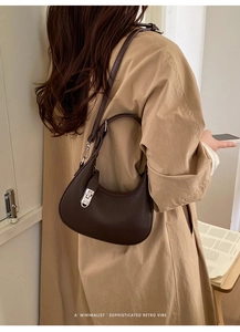 Close-up of a dark brown litchi pattern hobo bag featuring a silver metal twist lock