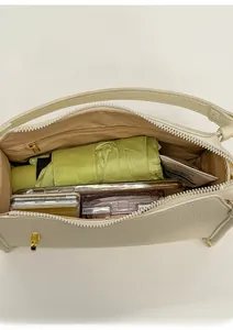 Top view of the cream shoulder bag interior showing large capacity and inner zipper pocket