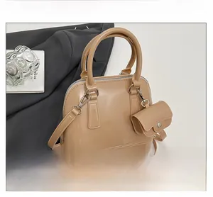 Detail of glossy jelly shell bag with mini coin purse attachment and shiny hardware