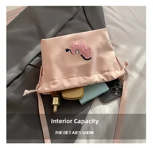 Internal view of the pink pleated cloud bag showing storage for phone and perfume