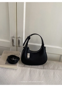 Detail of black lychee grain leather hobo bag with silver buckle and adjustable strap