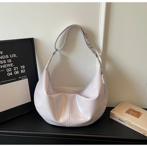 Detail of the glossy lavender hobo bag with sleek silver hardware and stitching