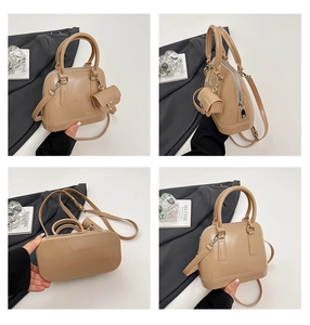 Detail view of beige jelly shell bag with detachable mini pouch and adjustable strap