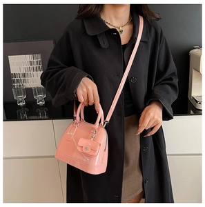 Close-up of pink jelly Boston bag featuring glossy PVC texture and matching mini pouch