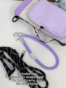 Detail of purple and white mini crossbody bag featuring dual interchangeable woven straps