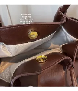 Detail of the brown leather tote bag with invisible magnetic snap and herringbone lining