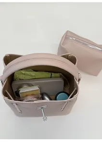 Detailed top view of purple litchi leather bucket bag interior with accessories