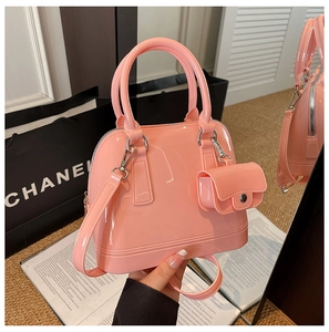 Detail of pink jelly crossbody bag with detachable mini pouch and glossy PVC texture