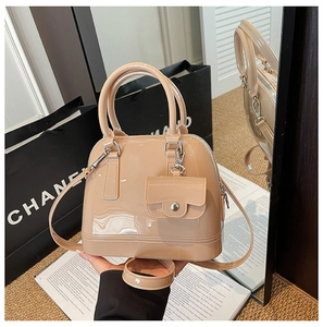 Detail of nude jelly shell bag with detachable strap and matching mini pouch accessory