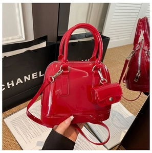 Macro shot of red jelly handbag with silver hardware and a matching mini pouch