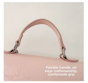 Detail of pink backpack handle showing durable edge oil craftsmanship and flexible texture