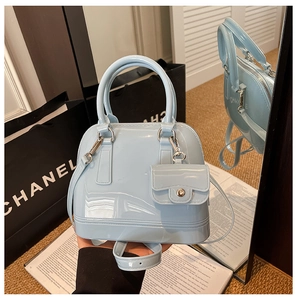 Detail of light blue jelly crossbody bag with matching coin purse and detachable strap