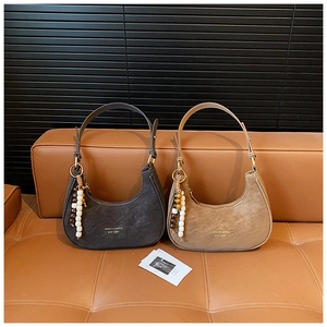 Detail of half-moon shoulder bags in dark brown and khaki with adjustable straps