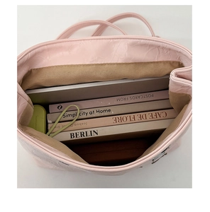 Spacious pink tote bag interior showing laptop and books storage capacity