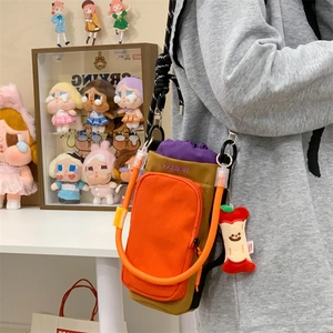 Detail of crossbody phone bag with Welldone embroidery and apple plush keychain