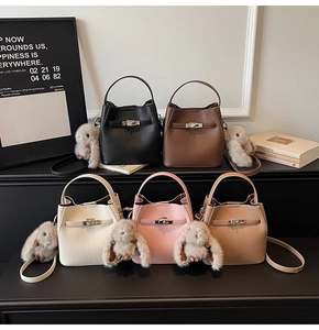 Collection of litchi grain leather bucket bags in five colors with plush rabbit charms