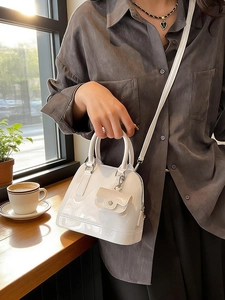 Glossy white jelly shell handbag with top handles and a mini coin purse charm