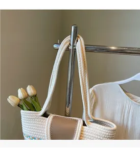 Close-up of handmade straw woven tote bag featuring faux leather tab and durable handles