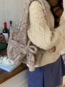 Large plush tote bag in beige faux fur with oversized bow detail for women