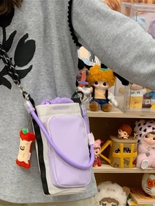 Fashionable mini crossbody phone bag in beige and purple with woven strap and charm