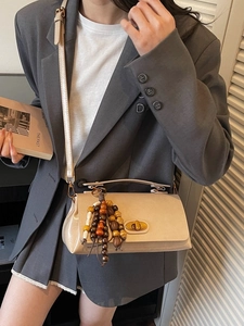 Vintage beige crossbody small square bag with golden twist lock and colorful wooden beads