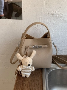 Brown litchi leather bucket bag with silver turn-lock and cute bunny charm pendant