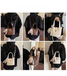 Litchi pattern leather bucket bag details with metal buckle and plush bunny charm