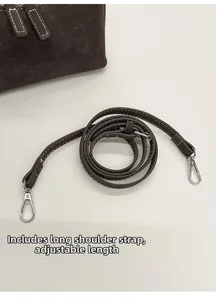 Detail of adjustable dark brown pebble leather shoulder strap with silver metal hooks