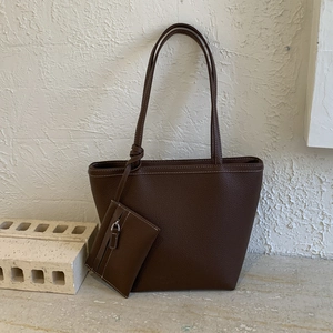 Detail of soft dark brown lychee grain tote bag with matching small zippered coin pouch