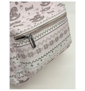 Detailed view of pink faux leather backpack featuring cute foal and strawberry patterns