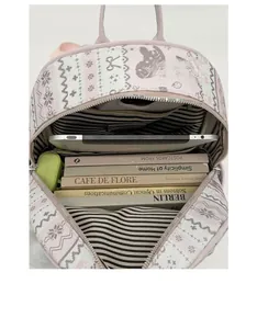 Internal view of pink backpack with striped lining holding tablets and textbooks