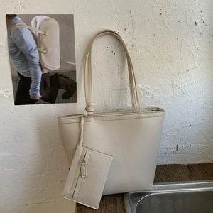 Detail of soft cream tote bag with matching zip pouch and pebble leather texture