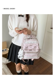 Detail shot of a pink campus backpack with cute horse prints and a plush bunny charm