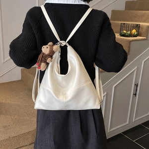Detailed back view of a creamy white PU leather tote backpack with a cute bear charm