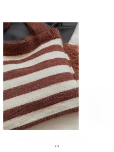 Gros plan détaillé du sac cabas en maille à rayures marron et blanc, texture douce