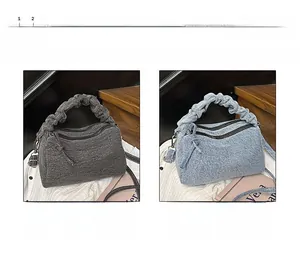 Detail of denim Boston bags with ruffled handles in black and denim blue colors