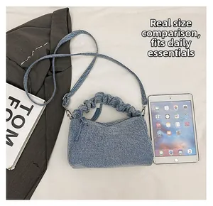 Blue denim crossbody bag size comparison with tablet and stylish scrunchie handle