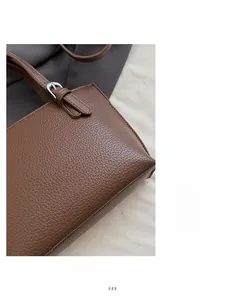 Close-up of brown litchi pattern leather texture with silver metal buckle detail