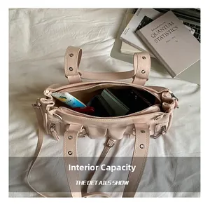 Macro view of interior capacity showing daily essentials in a beige pleated tote bag