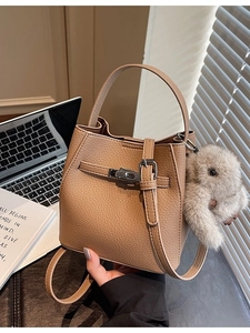 Litchi pattern leather bucket bag with silver lock and plush bunny charm accessory