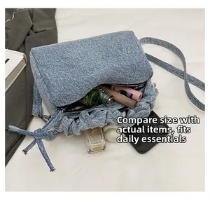 Capacity of the blue denim shoulder bag showing daily essentials like phone and perfume