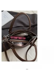 Interior view of brown lychee grain leather bucket bag showing large storage capacity