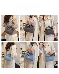 Detail view of denim pillow handbag showing versatile crossbody and shoulder carrying styles